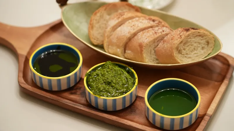 Sliced artisan bread with a selection of accompaniments.