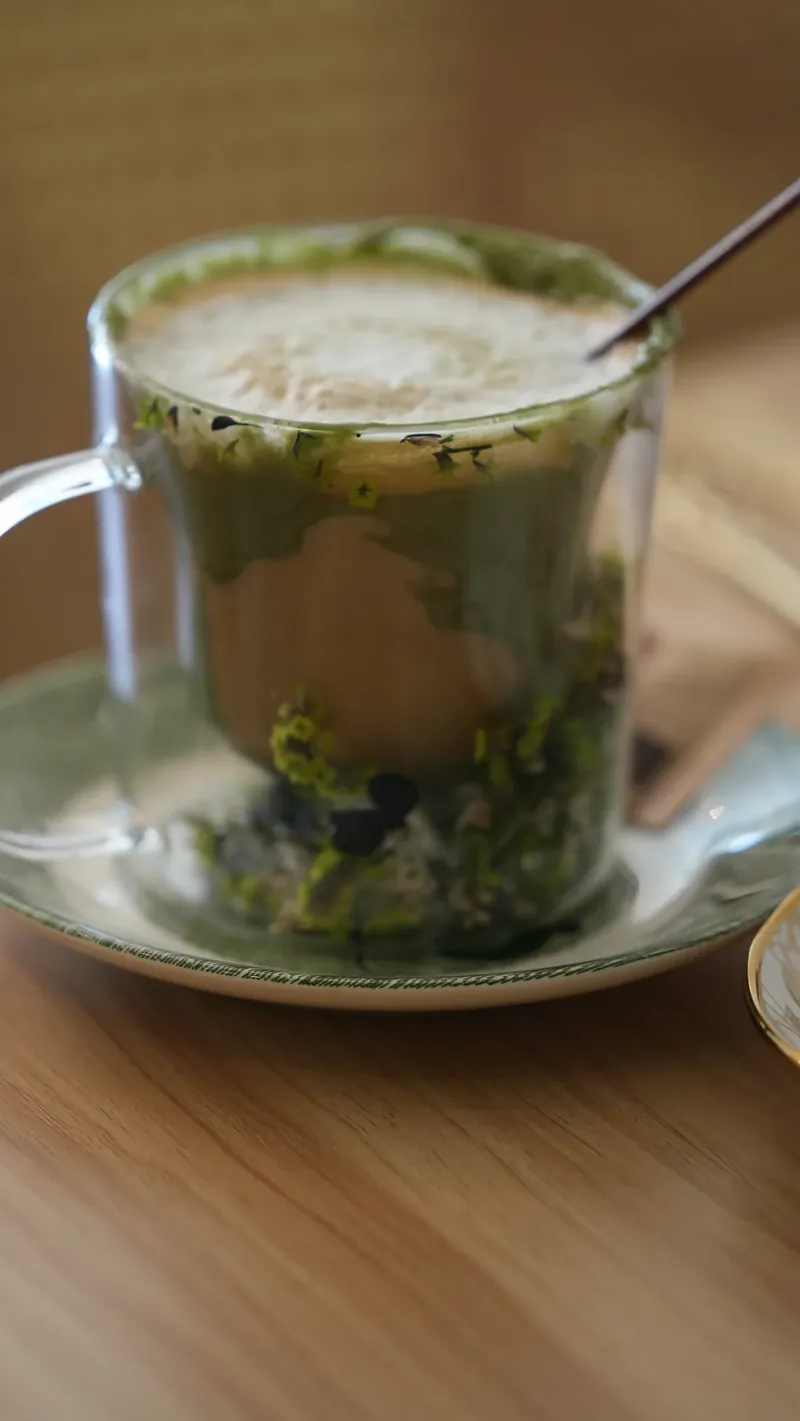 A handcrafted Maison Q matcha latte served in glassware.