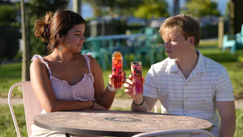 Guests enjoying vibrant iced fruit teas on the Maison Q patio.